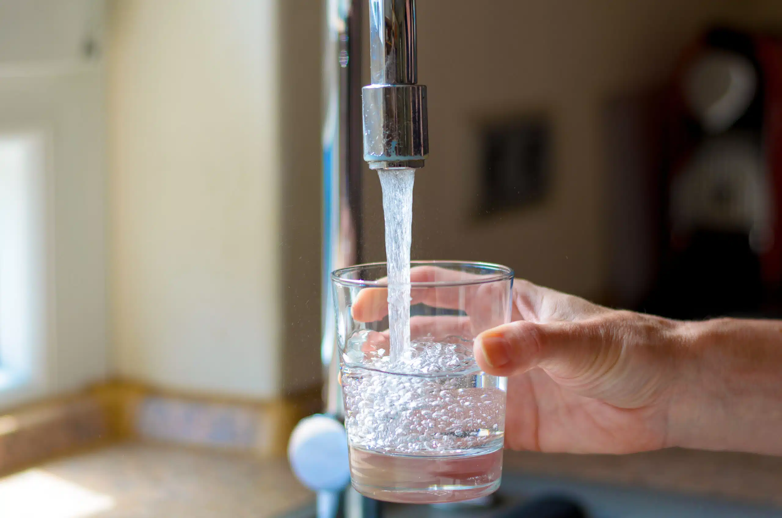 Pouring Water From a Tap Into a Glass